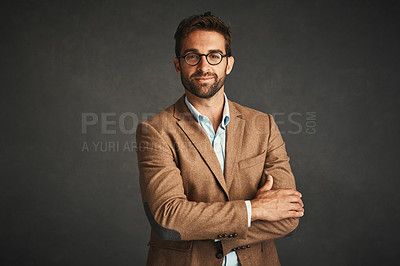 Buy stock photo Studio shot of a handsome young man posing against a gray background