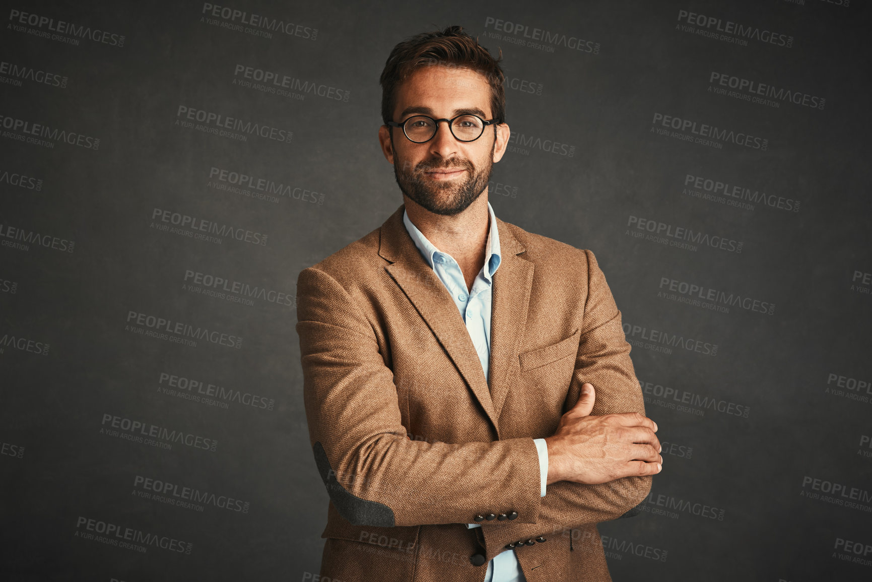 Buy stock photo Studio shot of a handsome young man posing against a gray background