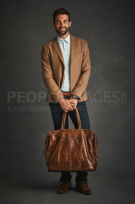 Buy stock photo Man, portrait and studio with luggage for travel, work style or smart casual fashion for professional confidence. Male professor, gray background and bag with jacket or cool, trendy blazer in Chicago