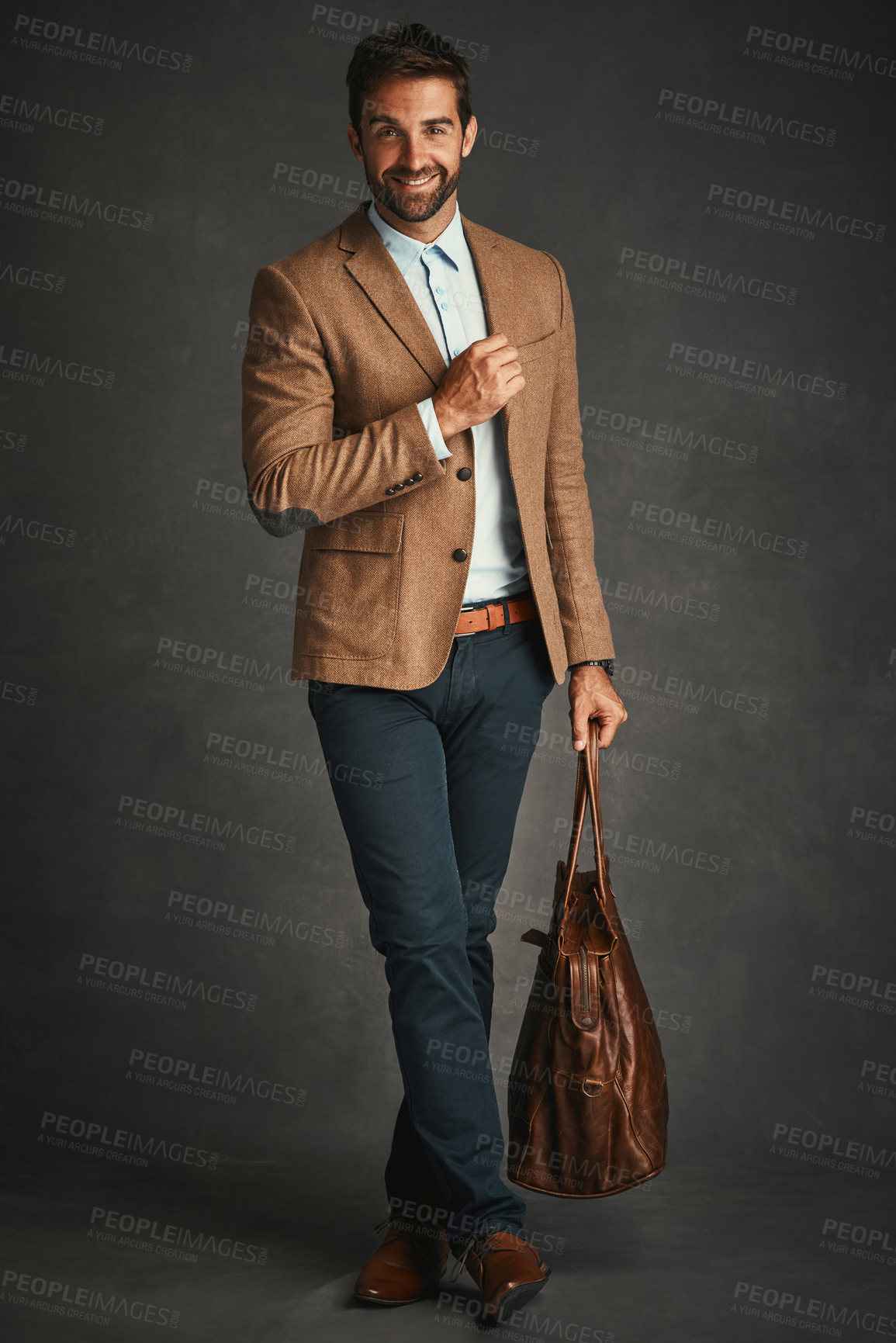 Buy stock photo Man, portrait and studio with bag for travel, work style or smart casual fashion for professional confidence. Male professor, gray background and luggage with jacket or cool, trendy blazer in Chicago