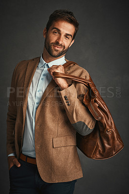 Buy stock photo Professor, portrait and studio with luggage for trip, work style or smart casual fashion for professional confidence. Man, gray background and travel bag with jacket or cool, trendy blazer in Chicago