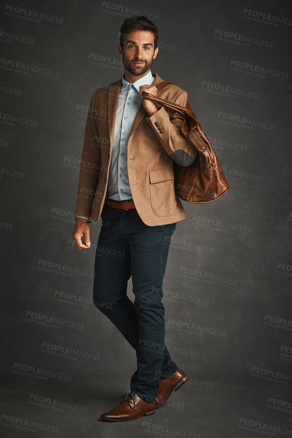 Buy stock photo Fashion, portrait and business man in studio with trendy style, accessory and formal clothes. Professional, happy entrepreneur and person with bag with confidence, pride and smile on gray background