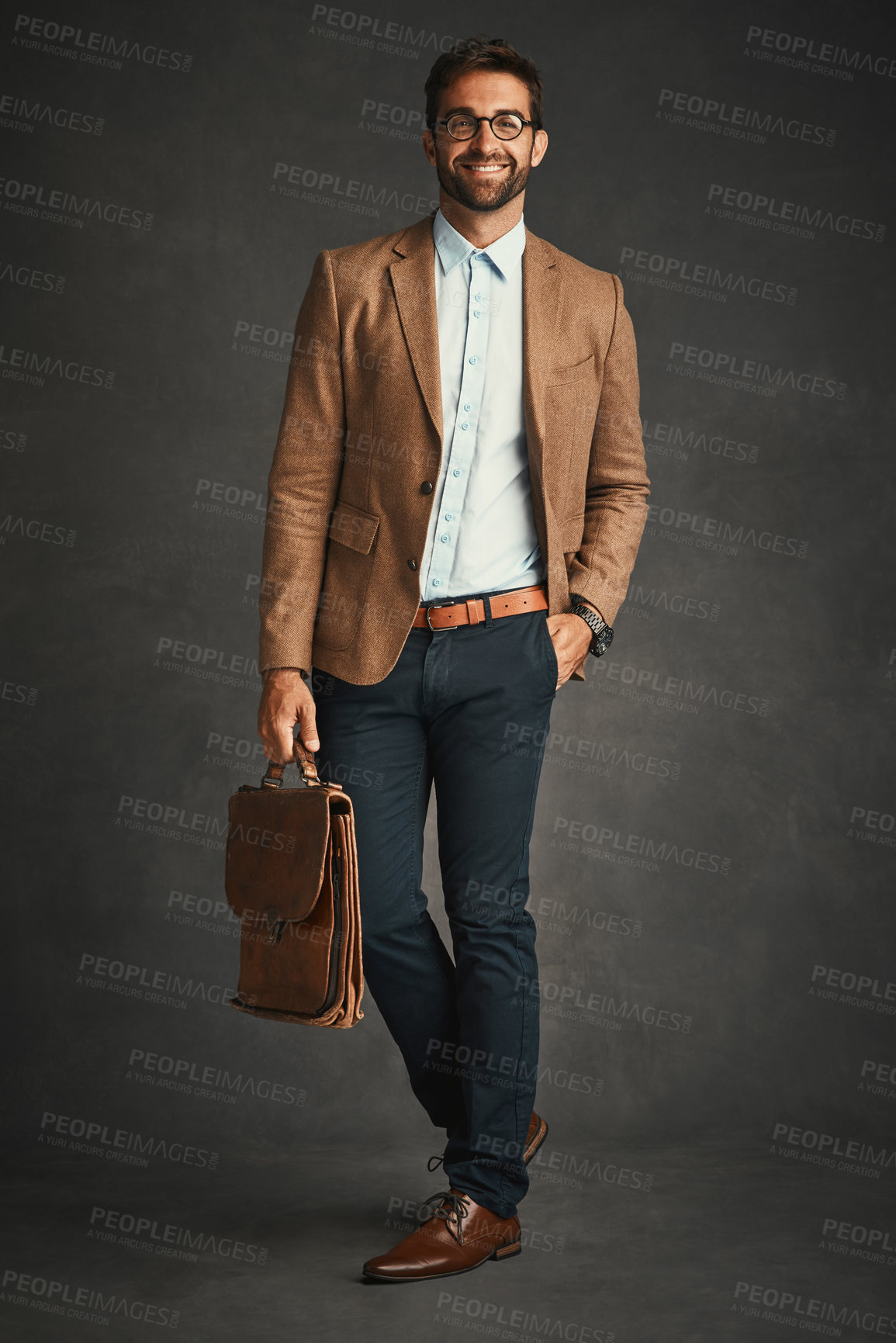 Buy stock photo Studio shot of a handsome young man posing against a gray background