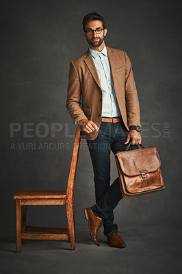 Buy stock photo Studio shot of a handsome young man posing against a gray background