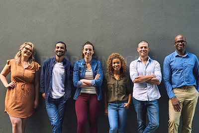 Buy stock photo Shot of a group cheerful friends standing together for a portrait while looking at the camera
