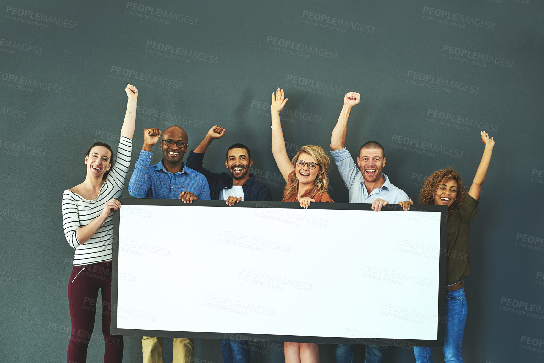 Buy stock photo Happy, diverse and cheering marketing team with a blank card, poster or billboard with copyspace in studio on a grey background. A group of smiling business people celebrating and endorsing a product