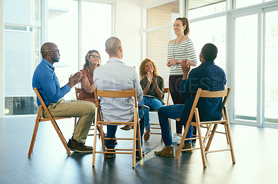 Buy stock photo Business woman coaching a teamwork seminar at work about job motivation and success. Group of office workers clapping hands after a team presentation. Smiling colleagues sitting together in a meeting