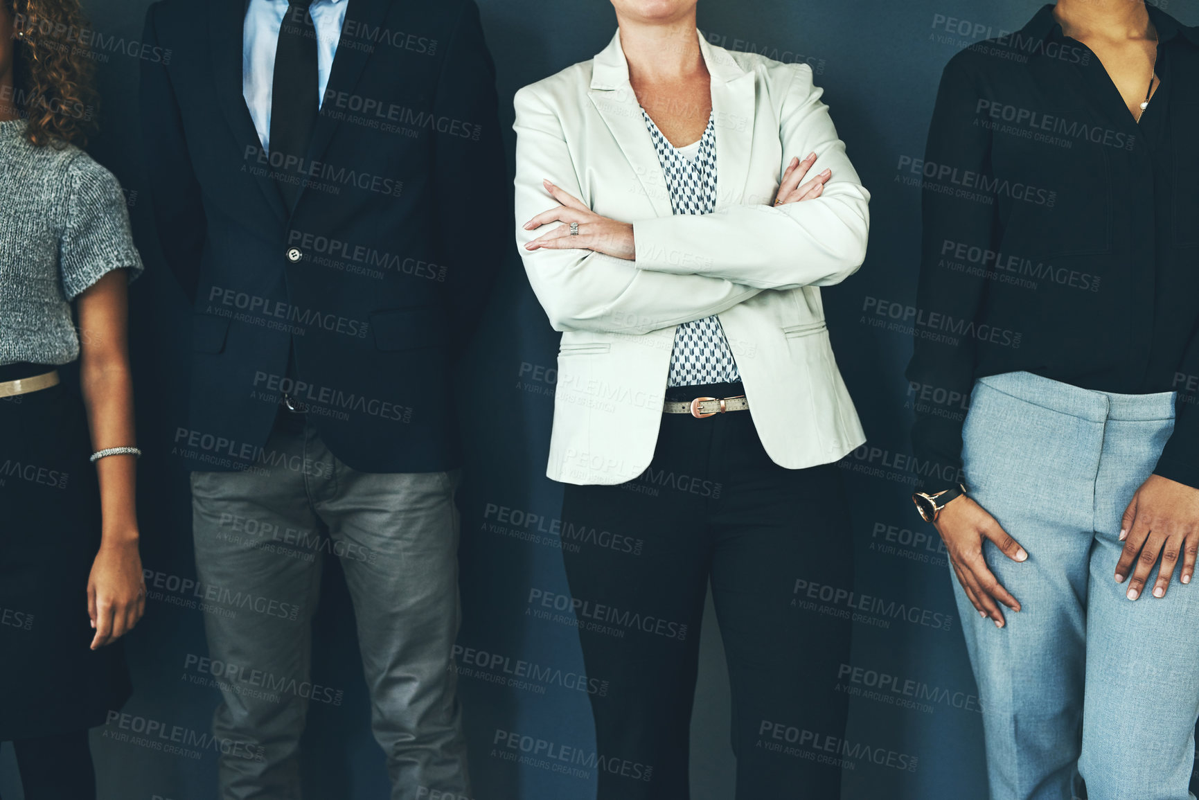 Buy stock photo Studio shot of a group of unrecognisable businesspeople posing against a dark background