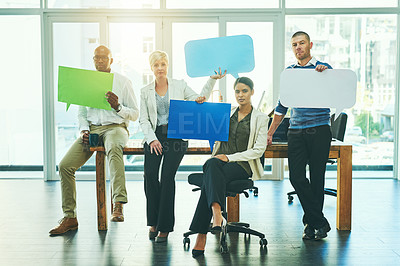Buy stock photo Portrait of a group of businesspeople holding speech bubbles in an office