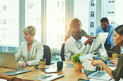 Buy stock photo Shot of a group of businesspeople working in an office