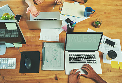 Buy stock photo Above, hands and team at desk with laptop, research and strategic planning in office. People, tech or papers in meeting for statistics, company development or budget control with screen or discussion