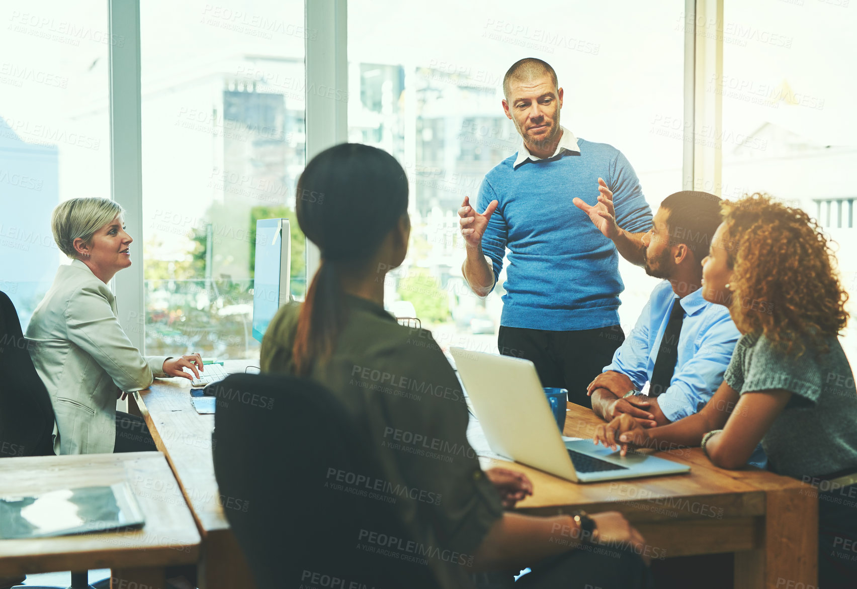 Buy stock photo Businessman, meeting and presentation with team in expansion, mission or company vision at office. Young group of employees listening to speaker in boardroom together for training, project or growth