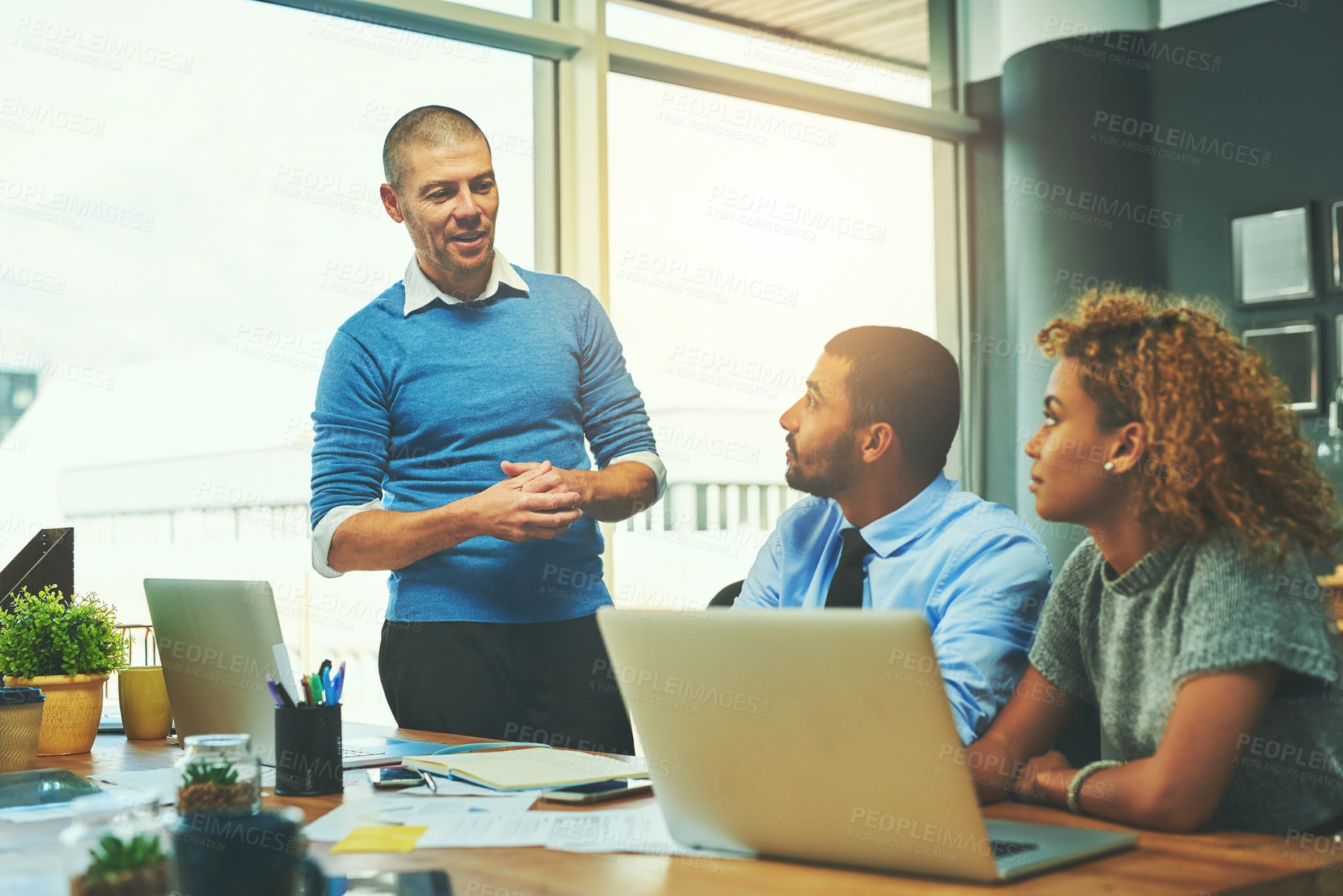 Buy stock photo Shot of a businessman giving a presentation to his colleagues in an office