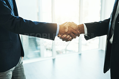 Buy stock photo Shot of two unrecognisable businessmen shaking hands in an office
