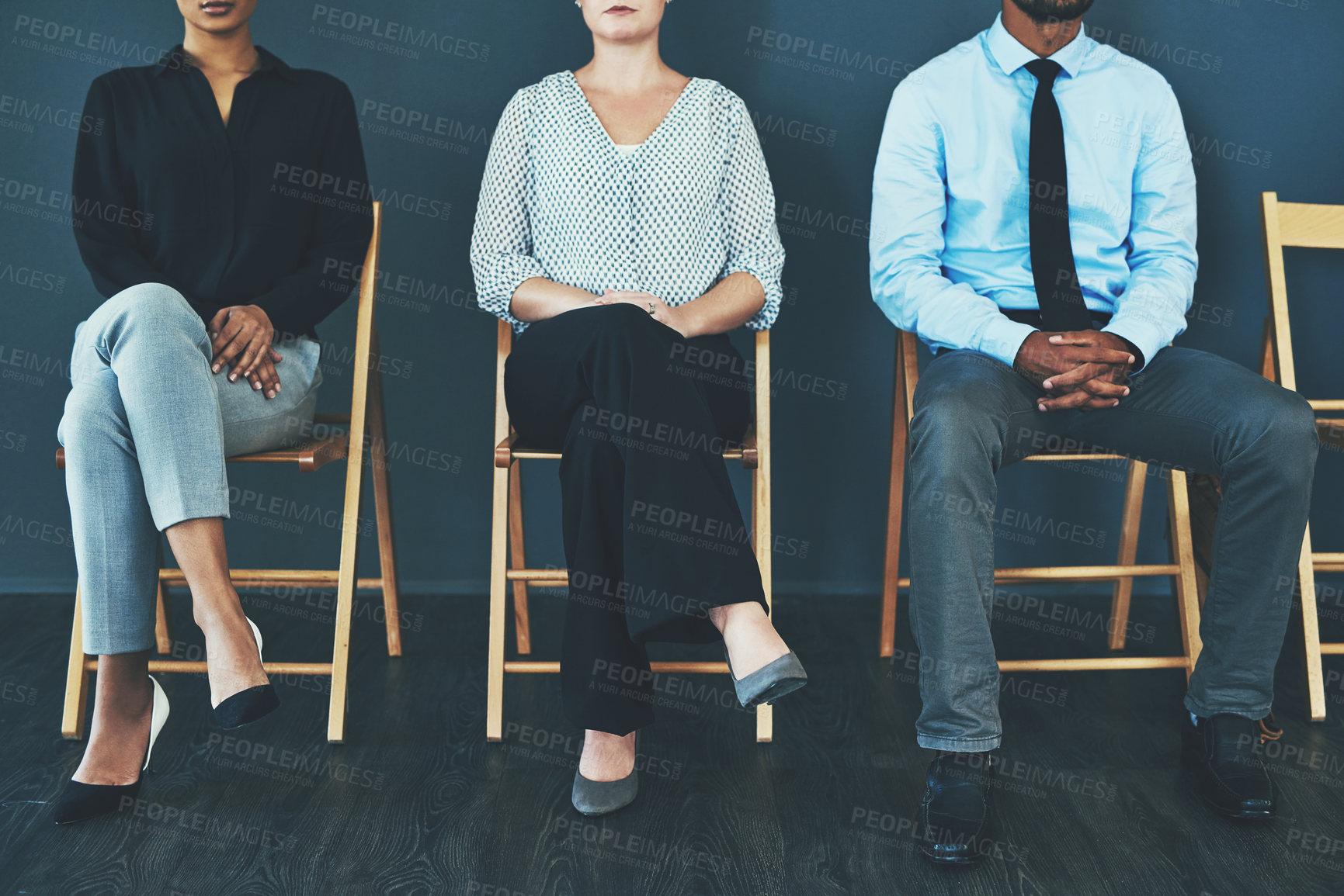 Buy stock photo Cropped of a group of well-dressed business people seated in line while waiting to be interview