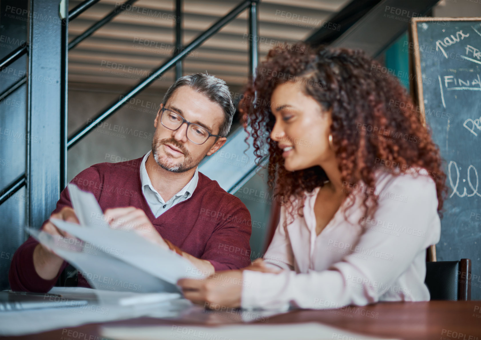 Buy stock photo Shot of two designers brainstorming together in an office