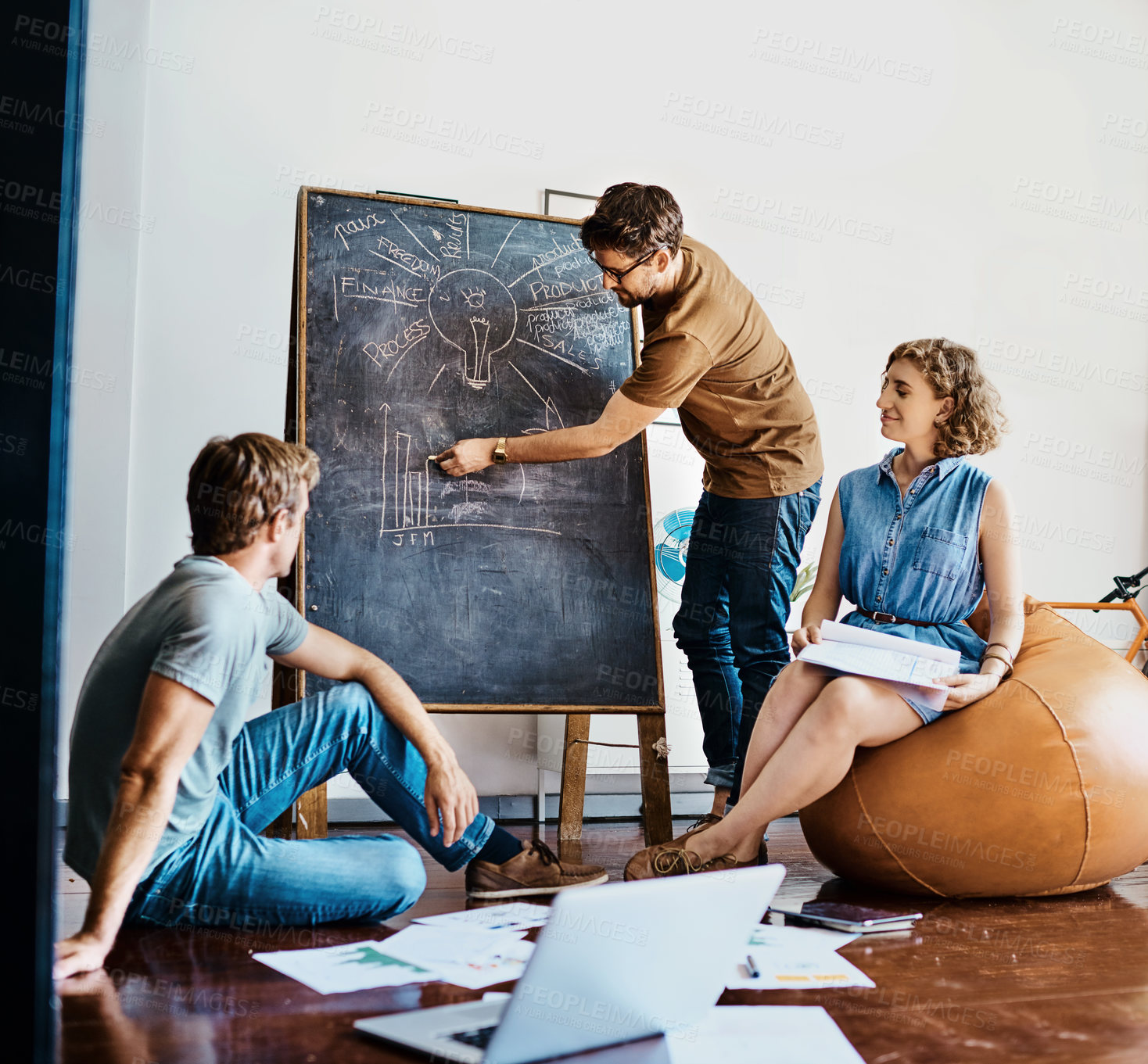 Buy stock photo Shot of a group of designers brainstorming together in an office