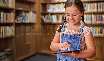 Buy stock photo Shot of a young girl using a digital tablet at school