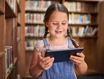 Buy stock photo Shot of a young girl using a digital tablet at school