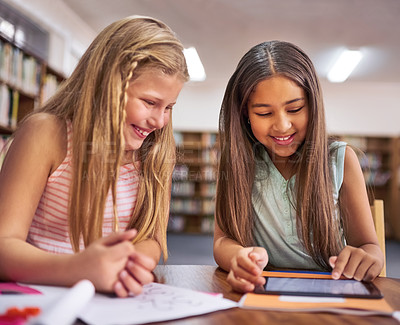 Buy stock photo Tablet, girl and friends in library for learning, education or reading info for knowledge. Happy students, child and smile on tech at school for studying, teamwork or watch online course together