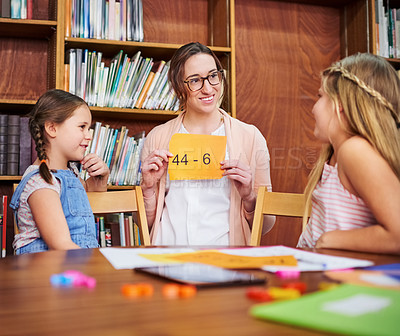 Buy stock photo Shot of a teacher using flashcards during a lesson with her students at school