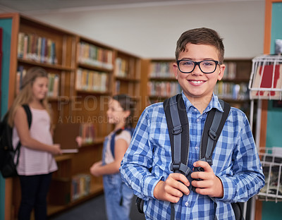 Buy stock photo Library, backpack and portrait of child in school with glasses for vision, studying or learning. Happy, face and young kid student with growth, development and education at academy for knowledge.