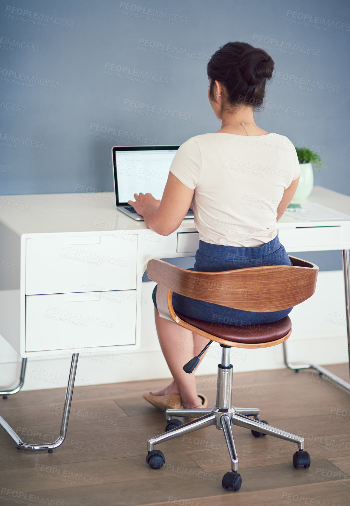 Buy stock photo Office, computer and back of business woman at desk working on online project, planning and typing email. Corporate worker, professional and person on laptop for internet, website and research