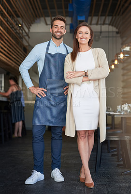 Buy stock photo Portrait of two young business owners standing in their cafe