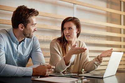 Buy stock photo Shot of two businesspeople having a meeting in a cafe