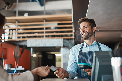 Buy stock photo Shot of a waiter processing a credit card payment from a customer in a cafe