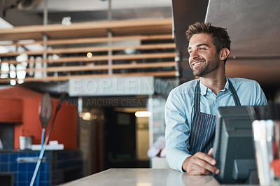 Buy stock photo Shot of a young entrepreneur working in a cafe