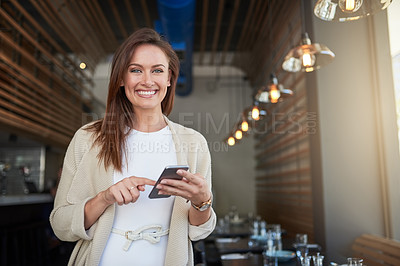 Buy stock photo Portrait of a young entrepreneur texting on her cellphone in a cafe