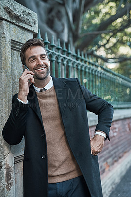 Buy stock photo Cropped shot of a handsome businessman using his cellphone while about town