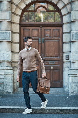 Buy stock photo Full length shot of a handsome businessman with a satchel about town