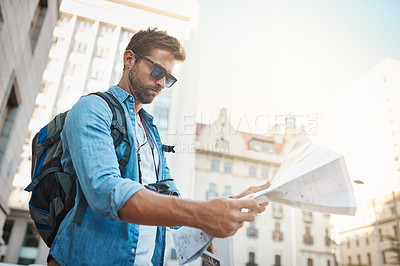 Buy stock photo Tourist, man and a map in a city for travel on a street with a backpack for location or direction. Male person with paper for navigation outdoor on urban road for adventure, journey or vacation