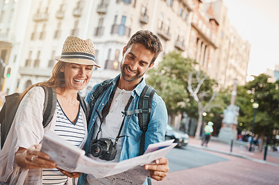 Buy stock photo Tourist, couple and a map in a city for travel and search for street, location or direction. Man and a woman reading a paper for navigation outdoor on urban road for adventure, journey or vacation
