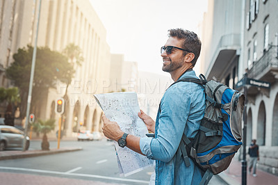 Buy stock photo Man, tourist and a map in a city for travel on a street with a backpack for location or direction. Male person with paper for navigation outdoor on urban road for adventure, journey or vacation