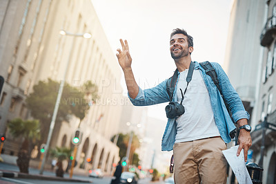 Buy stock photo Cropped shot of a young man taking photos while exploring a foreign city