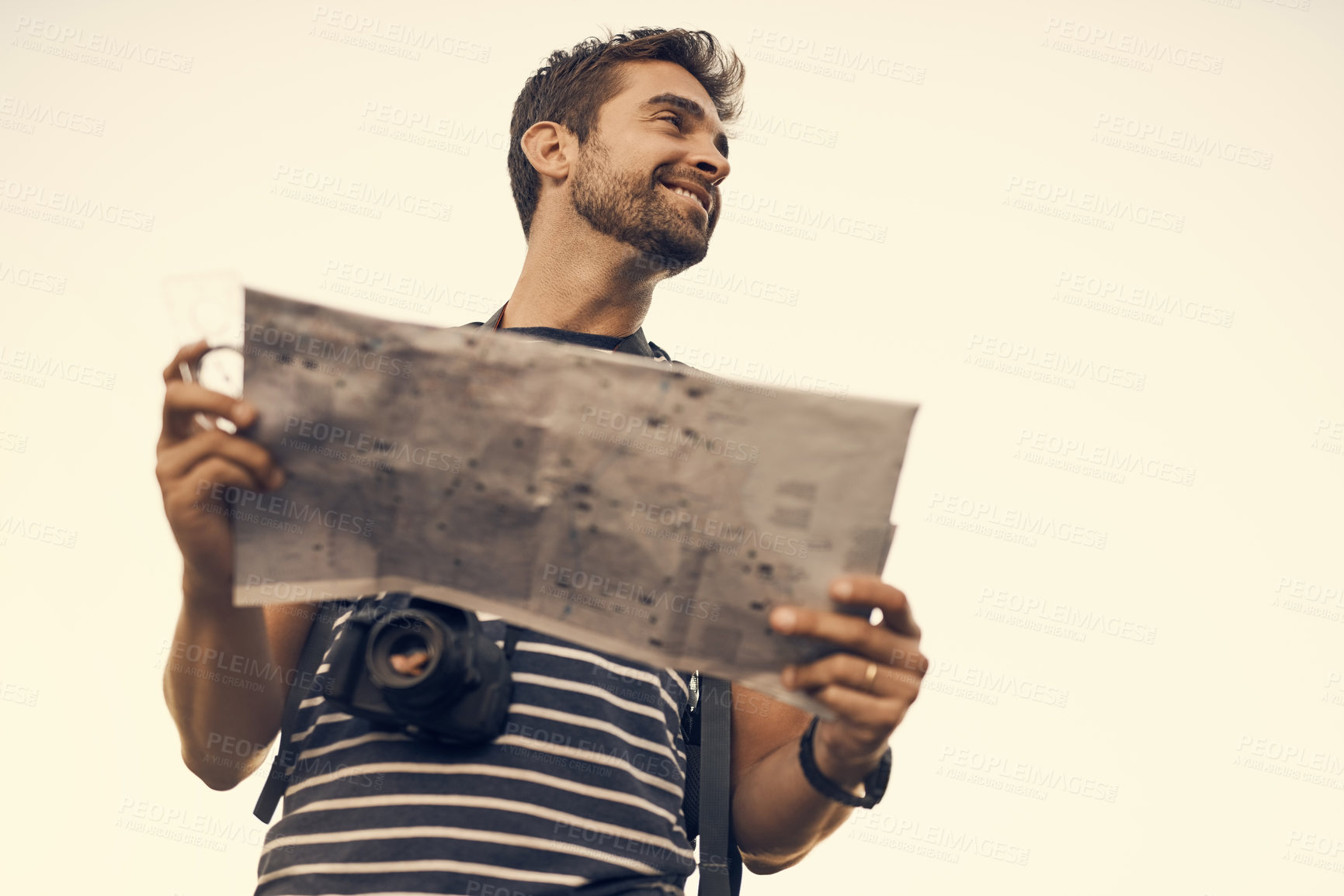 Buy stock photo Shot of a young man enjoying a hike through the mountains