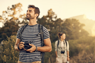Buy stock photo Shot of a man out hiking with his girlfriend following in the background