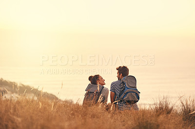 Buy stock photo Rearview shot of a couple taking a break after hiking