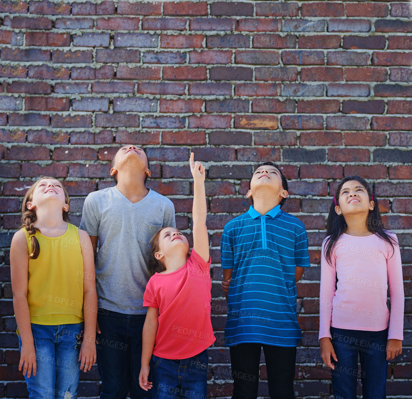 Buy stock photo Shot of a diverse group of children looking up outside