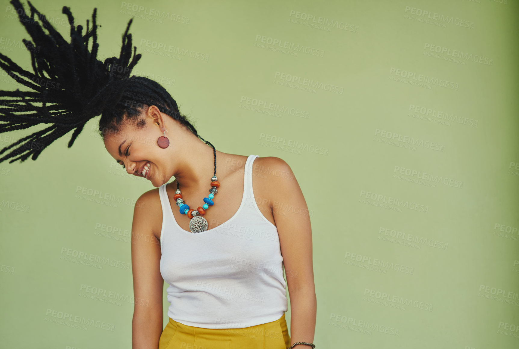 Buy stock photo Woman, energy and dreadlocks in studio for fashion, stylish clothes and cool look with confidence. Female person, jewelry and trendy accessory by mockup for laughing, dancing and green background