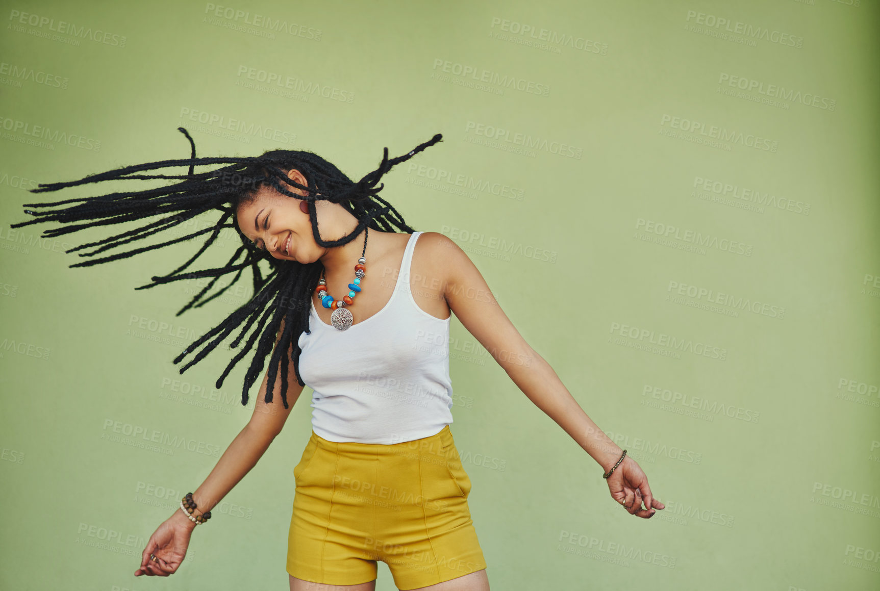 Buy stock photo Happy, dance and freedom with black woman in studio for energy, natural and hip hop. Happiness, talent and culture with african female dancer on green background for mockup, motivation and crazy