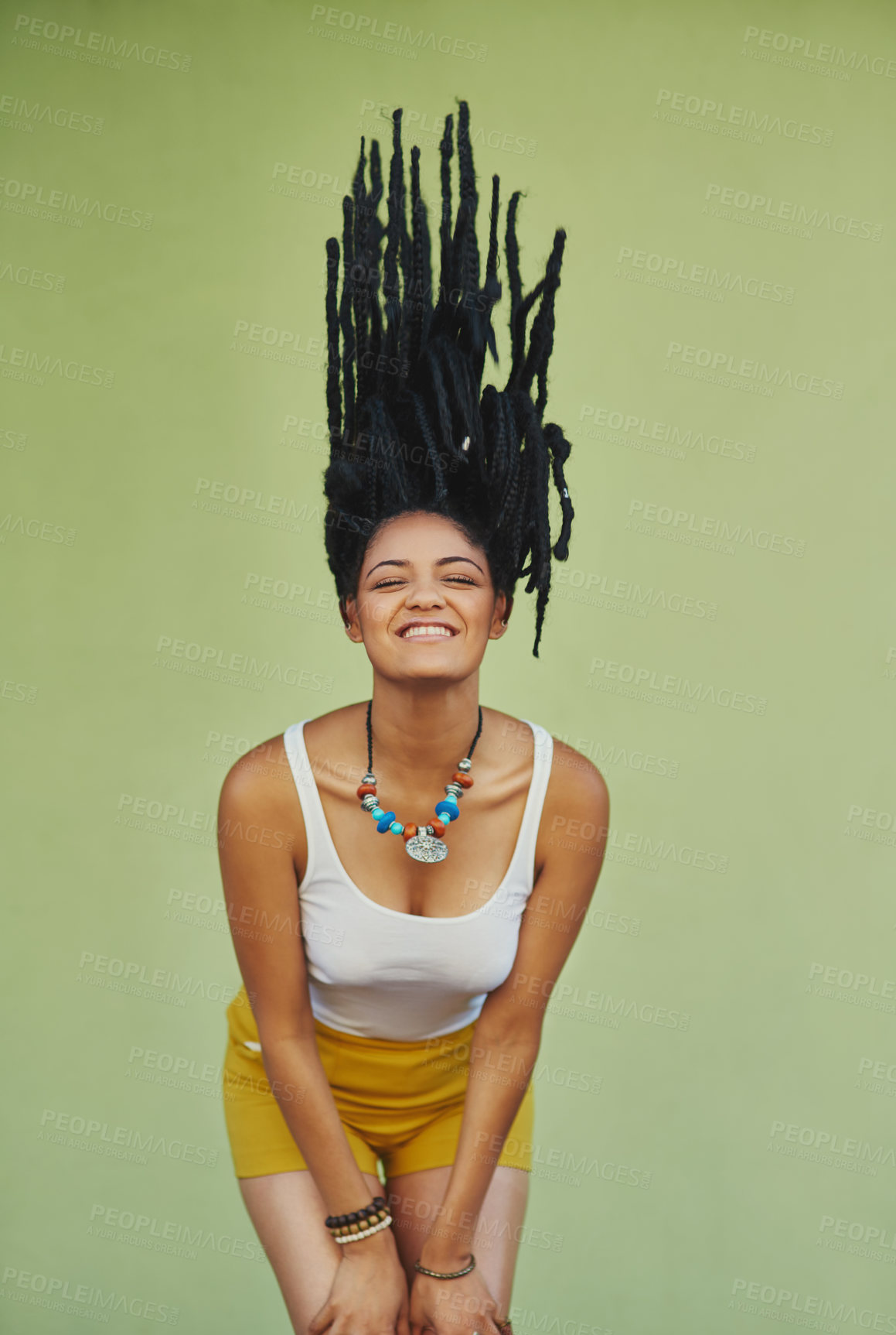 Buy stock photo Happy, woman and hair flip in studio with dreadlocks for summer fashion, jewellery or trendy style. Hairstyle, confidence and female person with smile for outfit, pride or clothes on green background