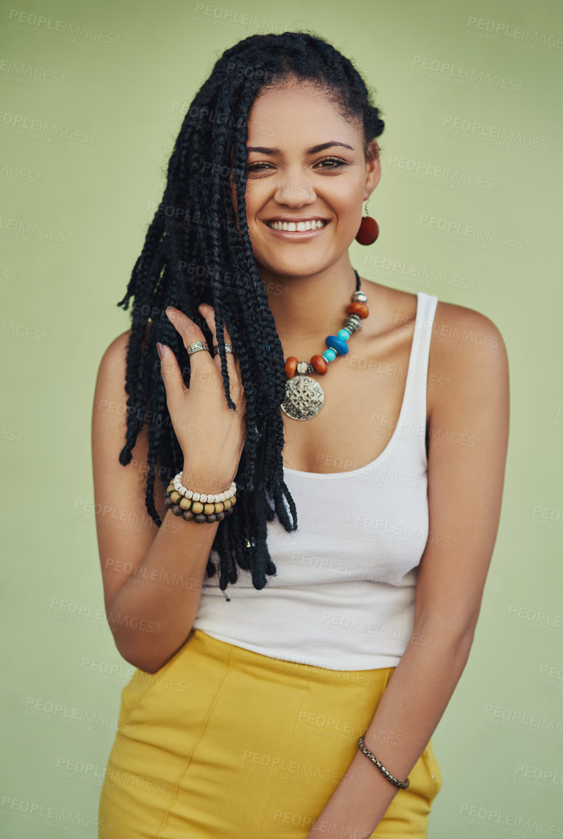 Buy stock photo Fashion, dreadlocks and happy woman in studio with casual, cool and trendy outfit for confidence. Portrait, smile and person with traditional jewelry for accessory with clothes by green background.