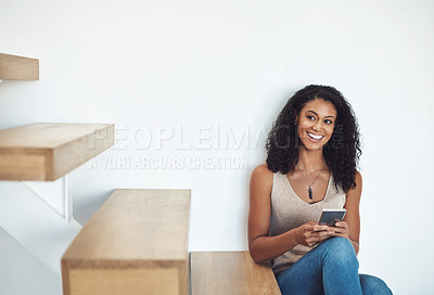 Buy stock photo Relaxed woman texting on phone while thinking, planning and dreaming of interior design ideas for new property. Smiling, happy and cheerful homeowner searching or browsing decorations for real estate