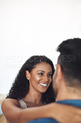 Buy stock photo Romantic hugging and bonding couple feeling in love with a copyspace background. Portrait of a young female smiling at her life partner loving romance. Closeup of a affectionate relationship