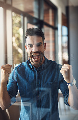 Buy stock photo Winning, celebrating and cheering young successful male entrepreneur happy for success in his business. Portrait of an excited and startup owner feeling joy, cheerful and positive for his company