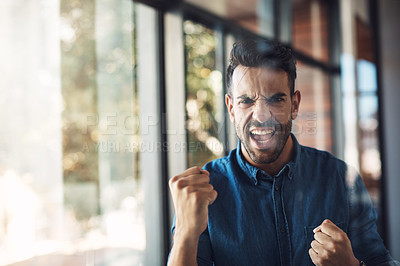 Buy stock photo Excited and confident business man cheering in his office and showing hand gesture. Successful and happy male celebrating work, a project or trading victory while standing near a window or glass wall